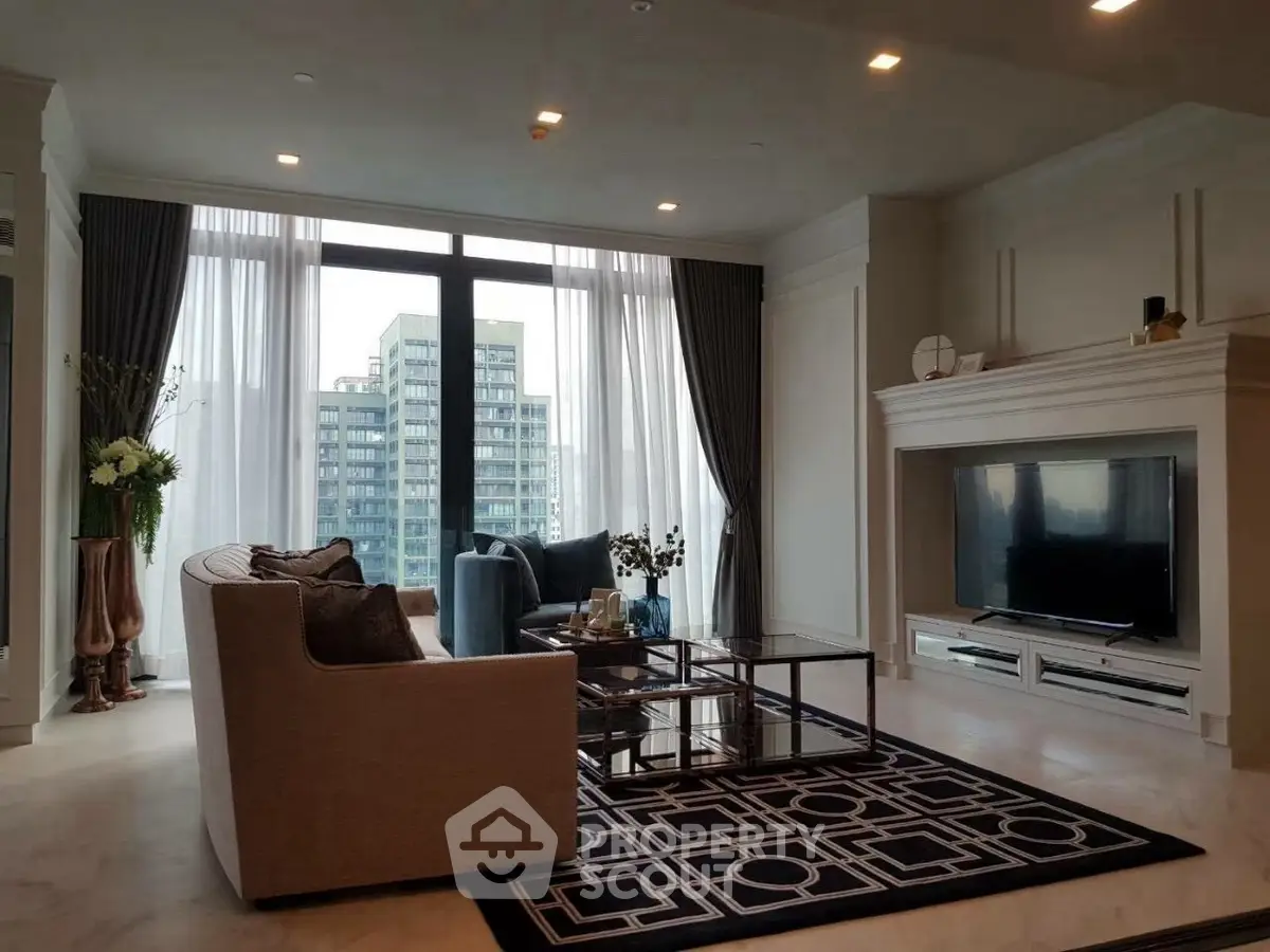 Luxurious living room with elegant decor and large windows offering stunning city views.