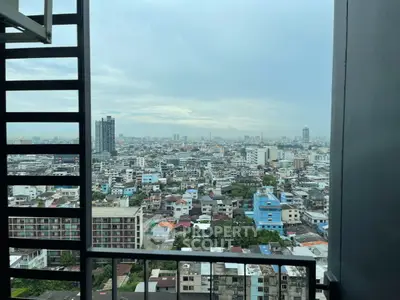 Stunning cityscape view from high-rise balcony showcasing urban skyline.