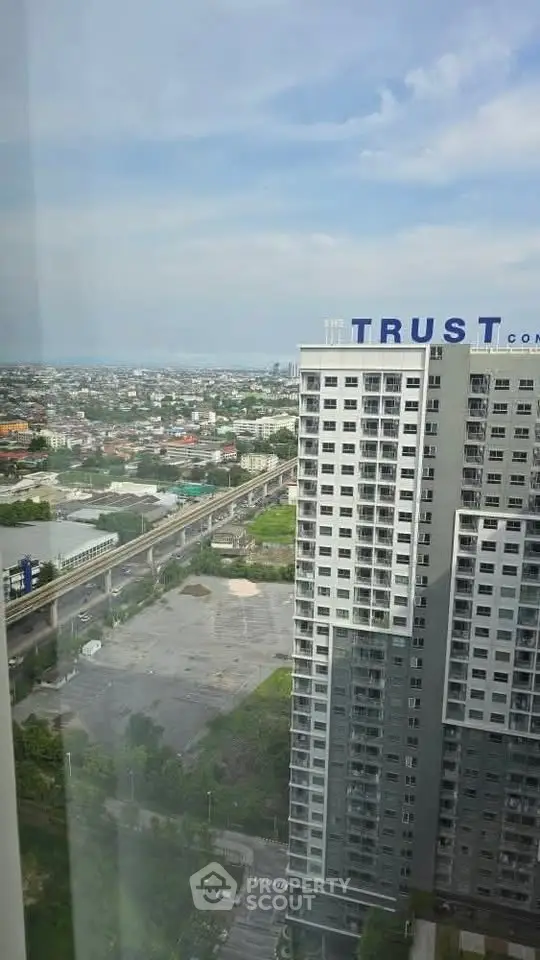High-rise building with panoramic city view and clear blue sky.