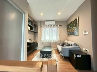 Cozy living room with modern decor and natural light, perfect for relaxation.