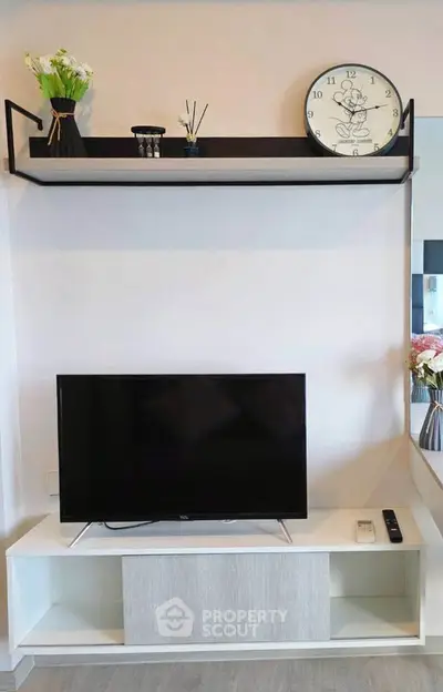 Modern living room with sleek TV stand and decorative shelf, perfect for stylish urban living.