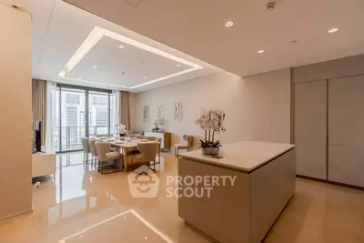 Luxurious open-plan living and dining area with modern decor and large windows offering city views.