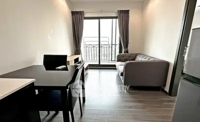 Modern living room with sleek furniture and balcony view in a stylish apartment.