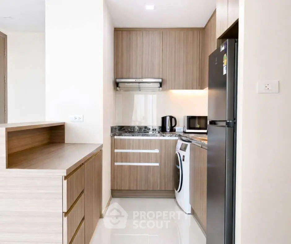 Modern kitchen with sleek cabinetry, appliances, and compact design