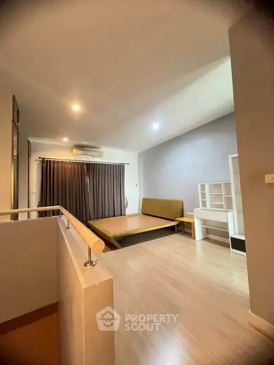 Spacious bedroom with modern design and ample natural light, featuring sleek flooring and stylish furnishings.