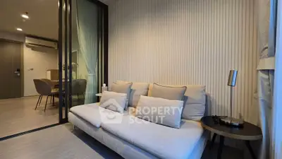 Modern living room with elegant decor and cozy seating in a stylish apartment.