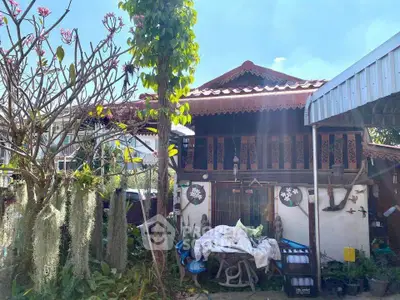 Charming traditional wooden house with lush garden and rustic decor, perfect for nature lovers seeking tranquility.