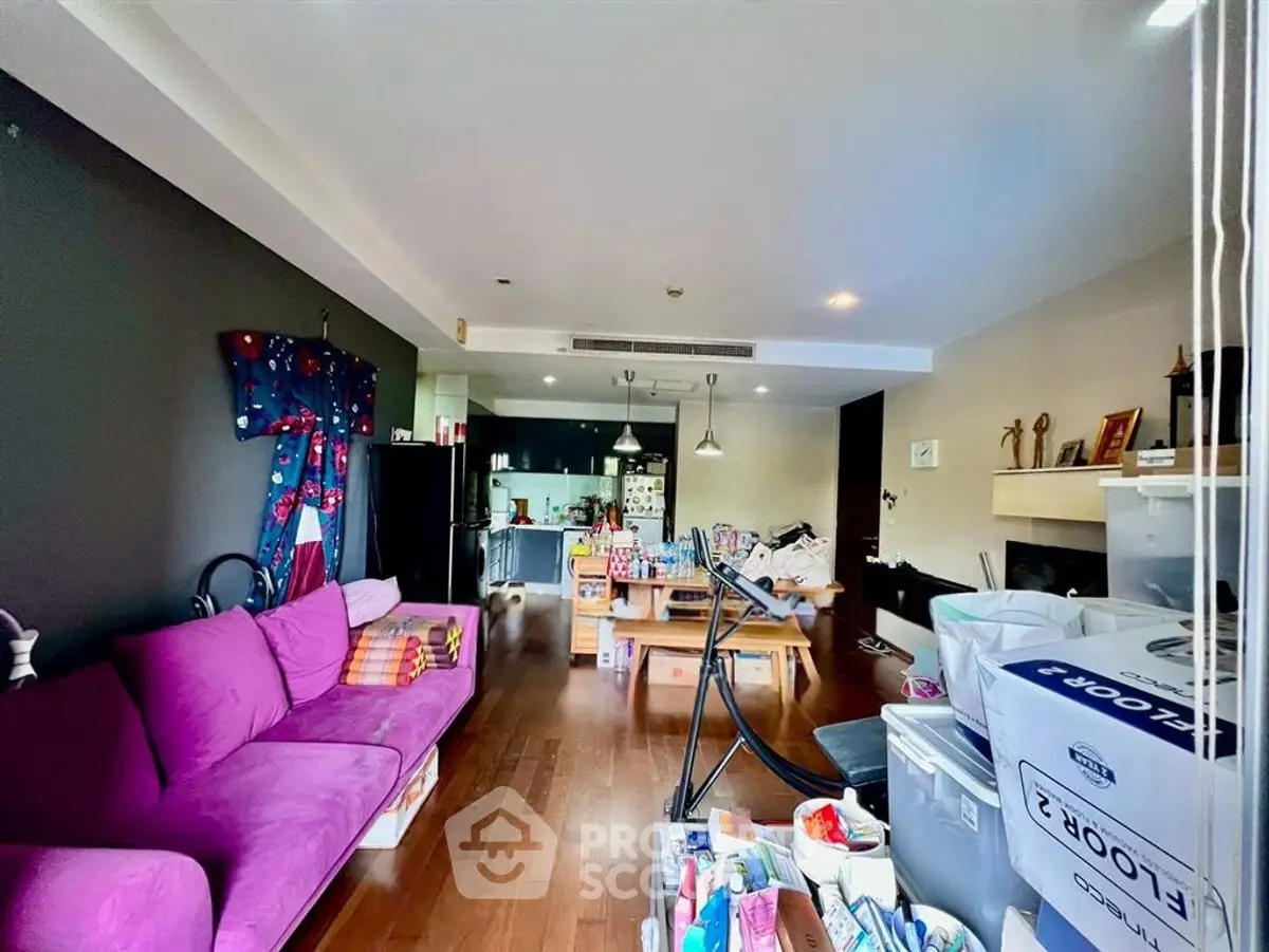 Spacious living room with vibrant decor and open kitchen layout