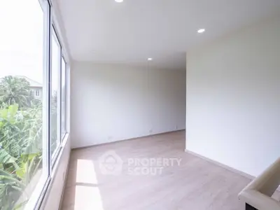 Spacious empty room with large windows and natural light, perfect for customization.