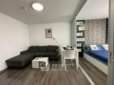Modern studio apartment with stylish living area and cozy bedroom, featuring sleek furniture and contemporary decor.