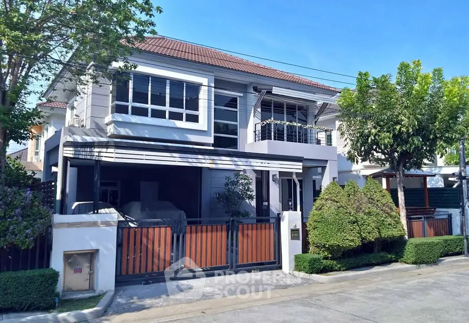 Charming two-story house with modern design and lush greenery in a serene neighborhood.