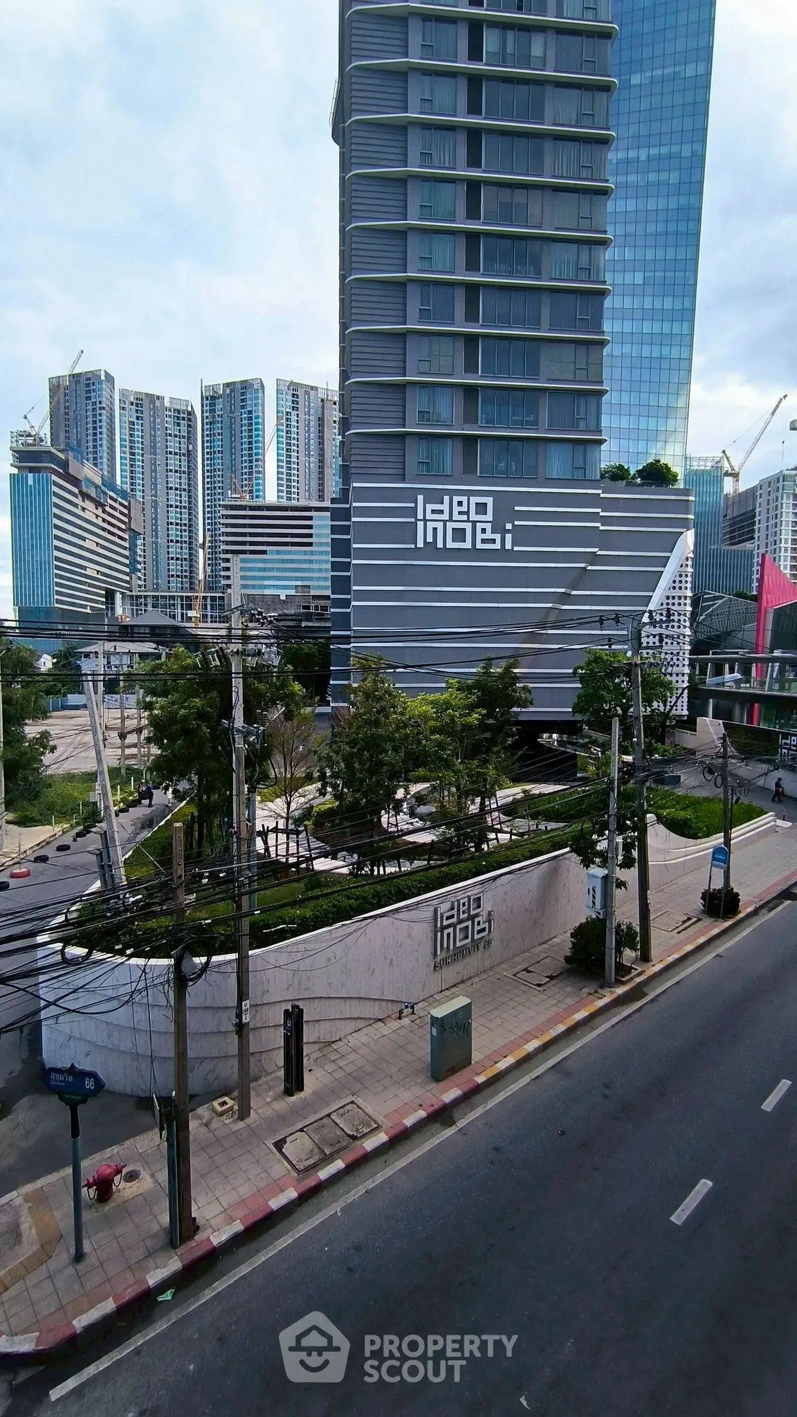 Modern high-rise building with sleek design in urban setting, showcasing contemporary architecture and city views.