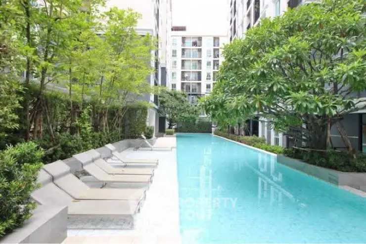 Luxurious residential pool area with modern design and lush greenery.
