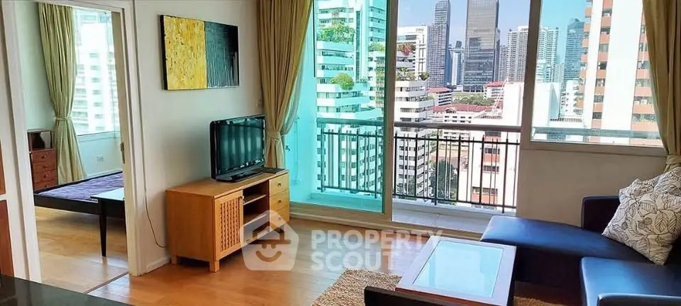 Bright living room with city view, modern furniture, and balcony access in urban apartment.