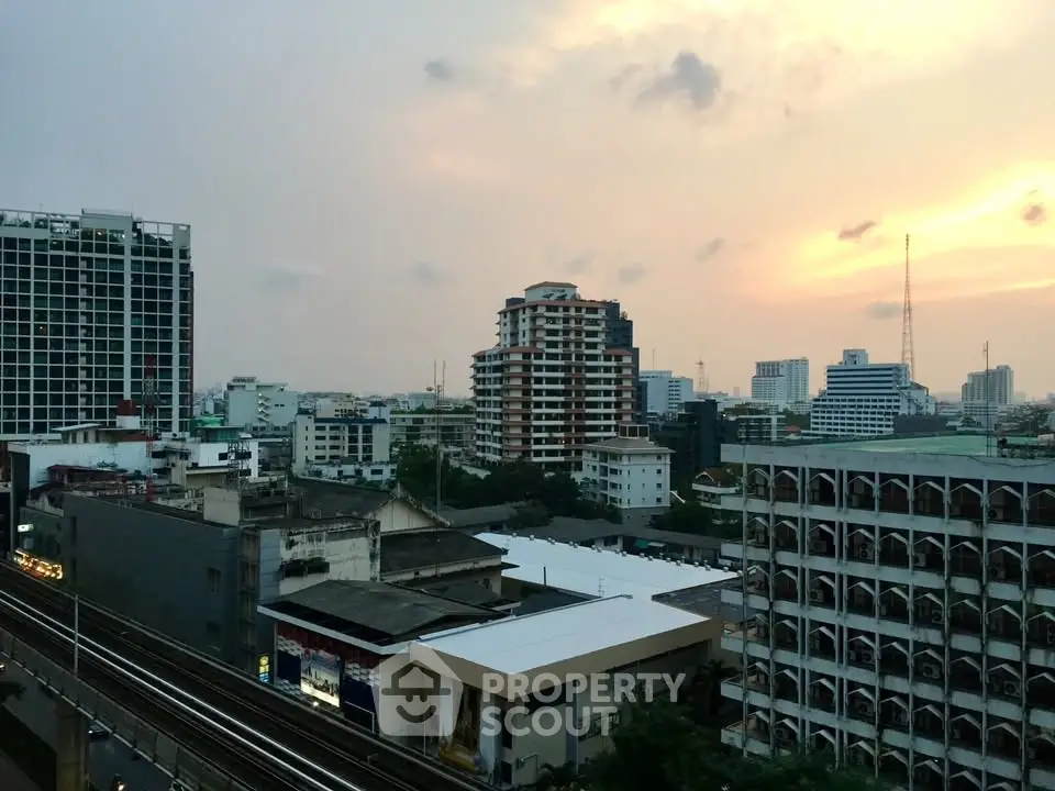 Stunning cityscape view from a high-rise building at sunset, showcasing urban skyline and vibrant architecture.
