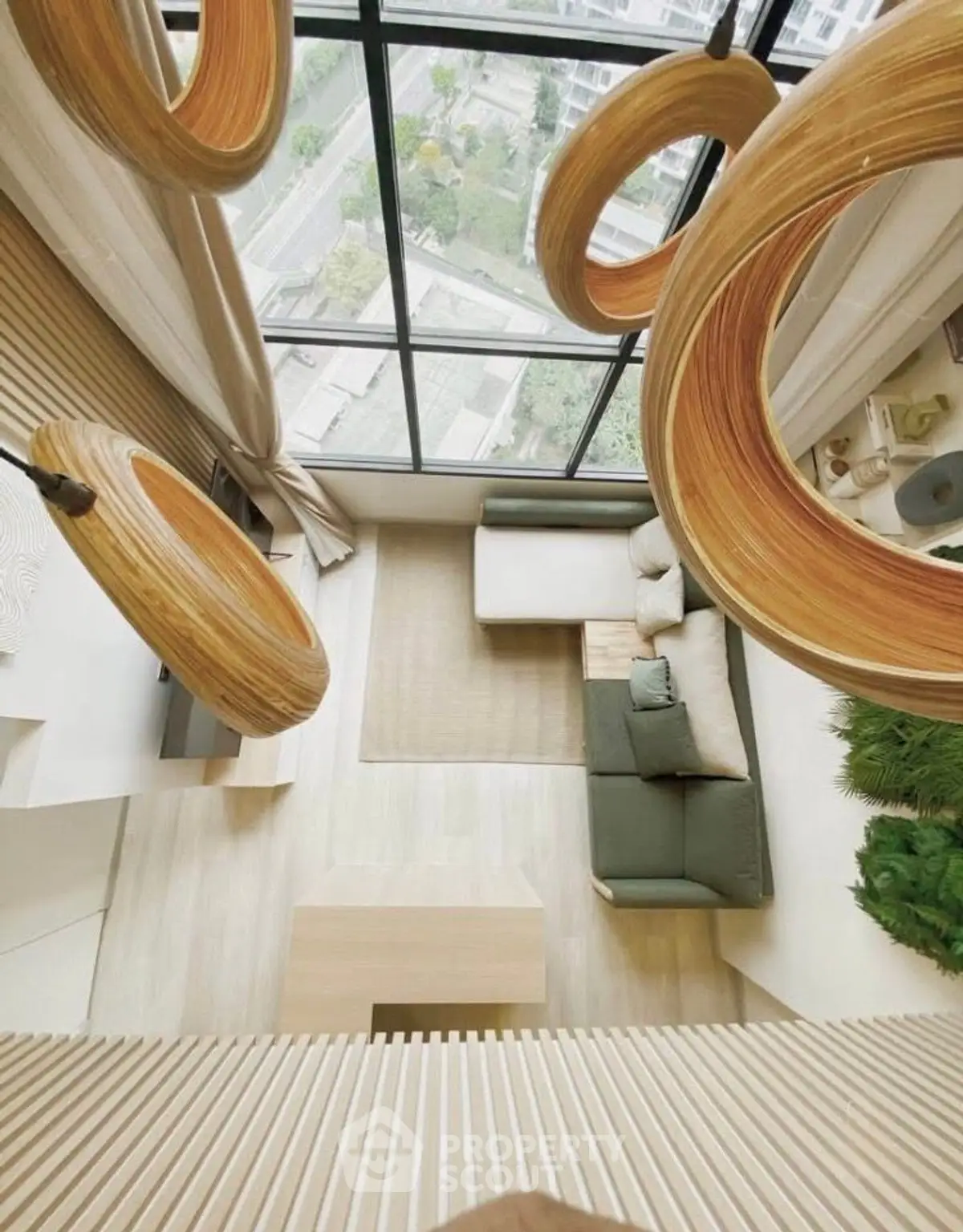 Stunning modern living room with floor-to-ceiling windows and unique wooden light fixtures.