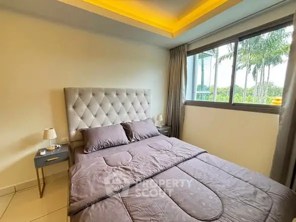 Luxurious bedroom with plush bed and large window offering serene garden views.