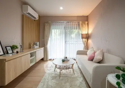 Modern living room with cozy sofa, stylish decor, and natural light through large windows.