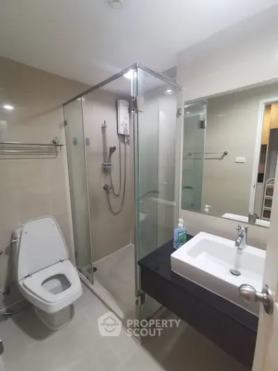 Modern bathroom with glass shower and sleek fixtures