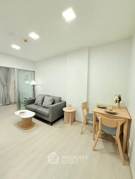 Modern living room with cozy sofa and dining area in minimalist style