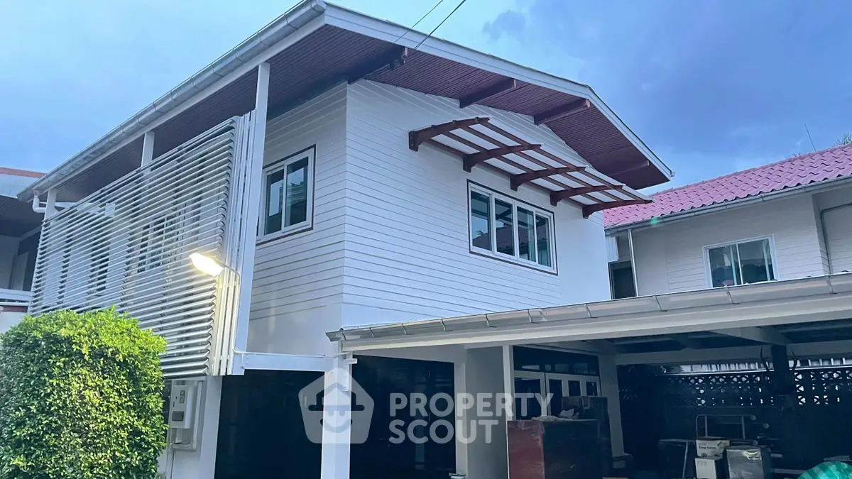 Charming two-story house with modern exterior and spacious carport