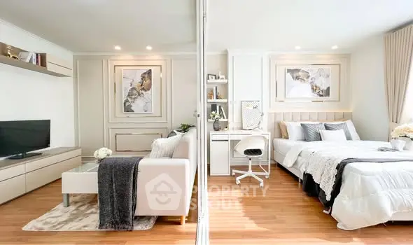 Modern open-plan living room and bedroom with stylish decor and natural light.