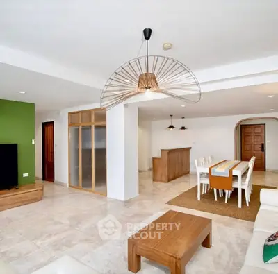 Spacious open-plan living and dining area with modern decor and natural light.