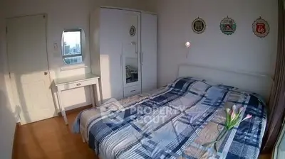 Cozy bedroom with stylish decor and ample natural light