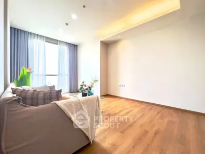 Spacious living room with elegant decor and large windows for natural light.