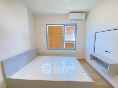 Modern minimalist bedroom with built-in air conditioning and sleek furniture design.