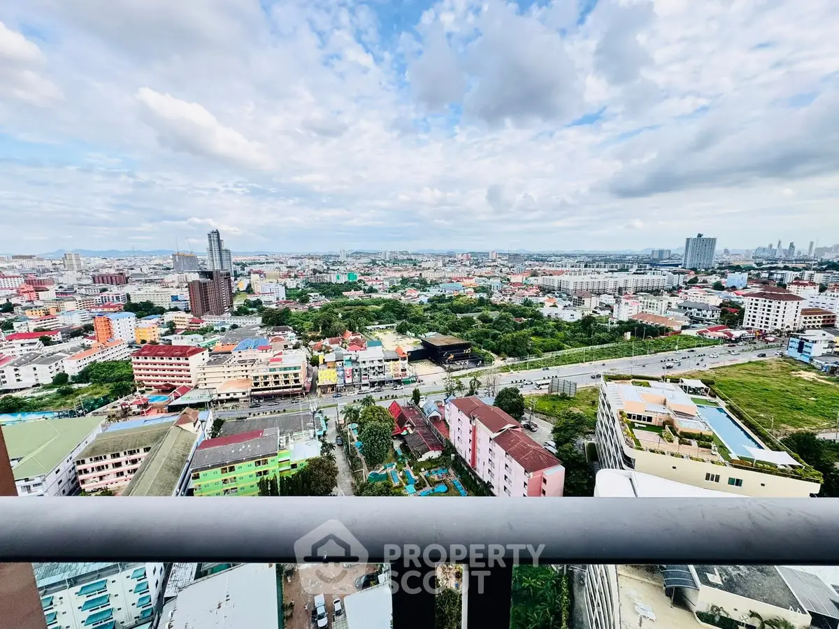Stunning cityscape view from high-rise balcony showcasing vibrant urban landscape.