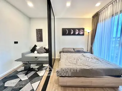 Modern bedroom with stylish decor and large windows for natural light