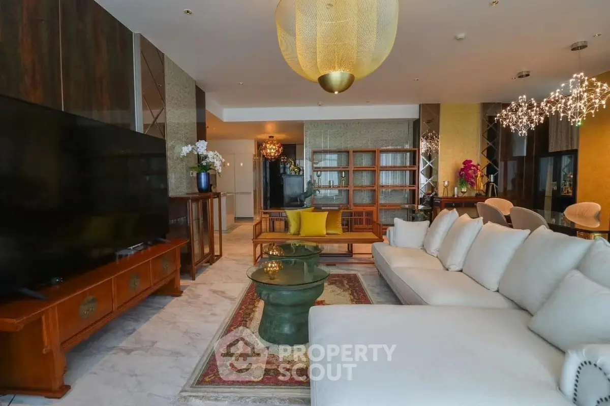 Luxurious living room with elegant decor and spacious seating area, featuring modern lighting and stylish furniture.