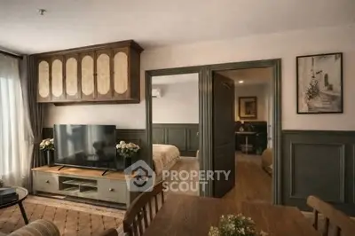 Charming living room with elegant decor and open view into cozy bedroom