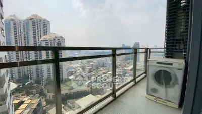 Stunning high-rise balcony view with cityscape and washing machine, perfect urban living.