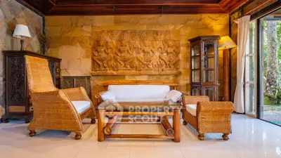 Luxurious living room with elegant wicker furniture and artistic wall decor in a serene setting.