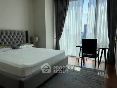 Luxurious bedroom with elegant decor and stunning city view through large windows.