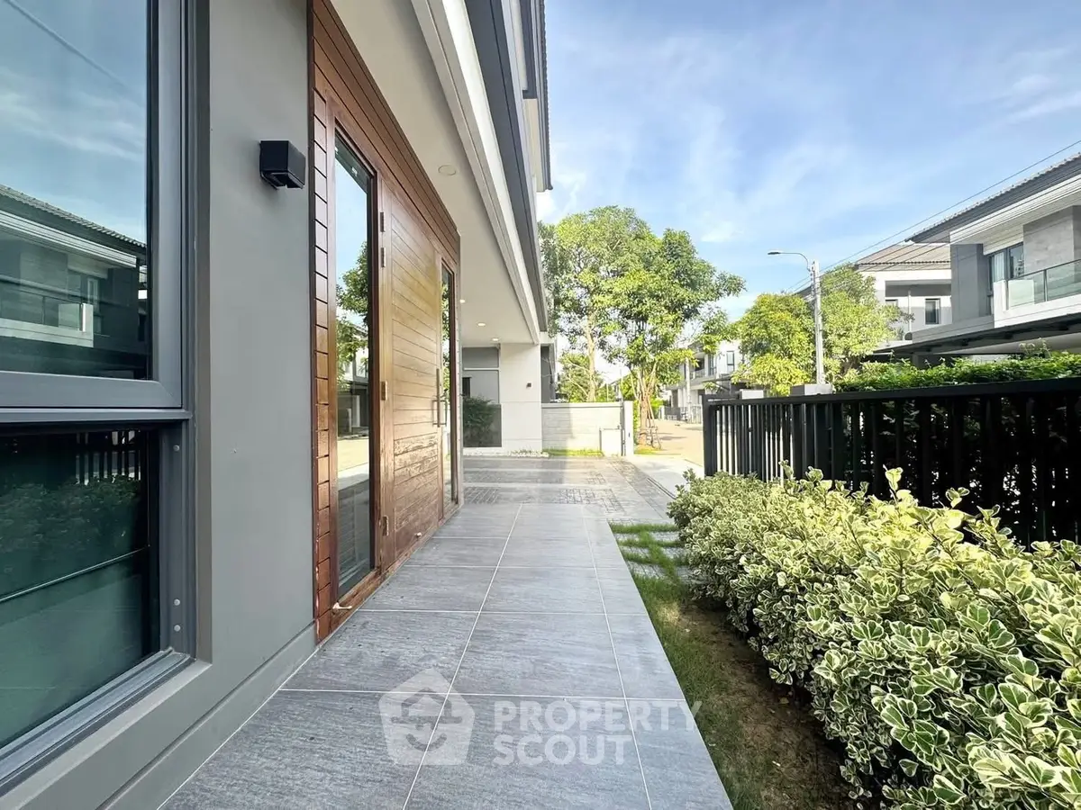 Modern house exterior with sleek design and lush greenery