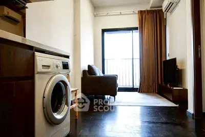 Modern living room with washing machine and balcony view, featuring sleek furniture and natural light.