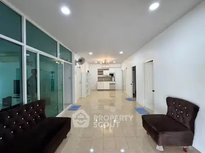 Spacious open-plan living room with modern kitchen and elegant seating area.