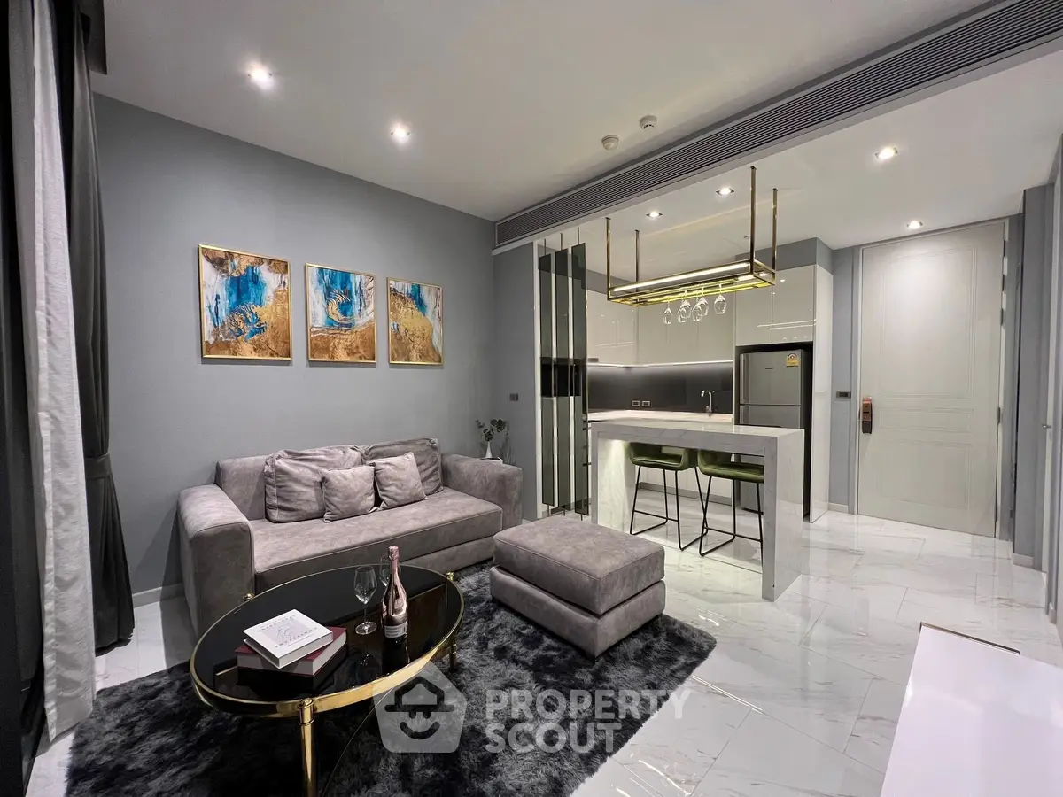 Luxurious modern living room with open kitchen, elegant decor, and stylish furniture in a contemporary apartment.