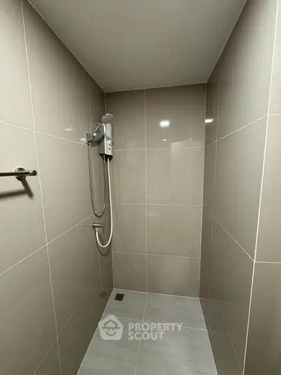 Modern minimalist bathroom with sleek tiles and shower area