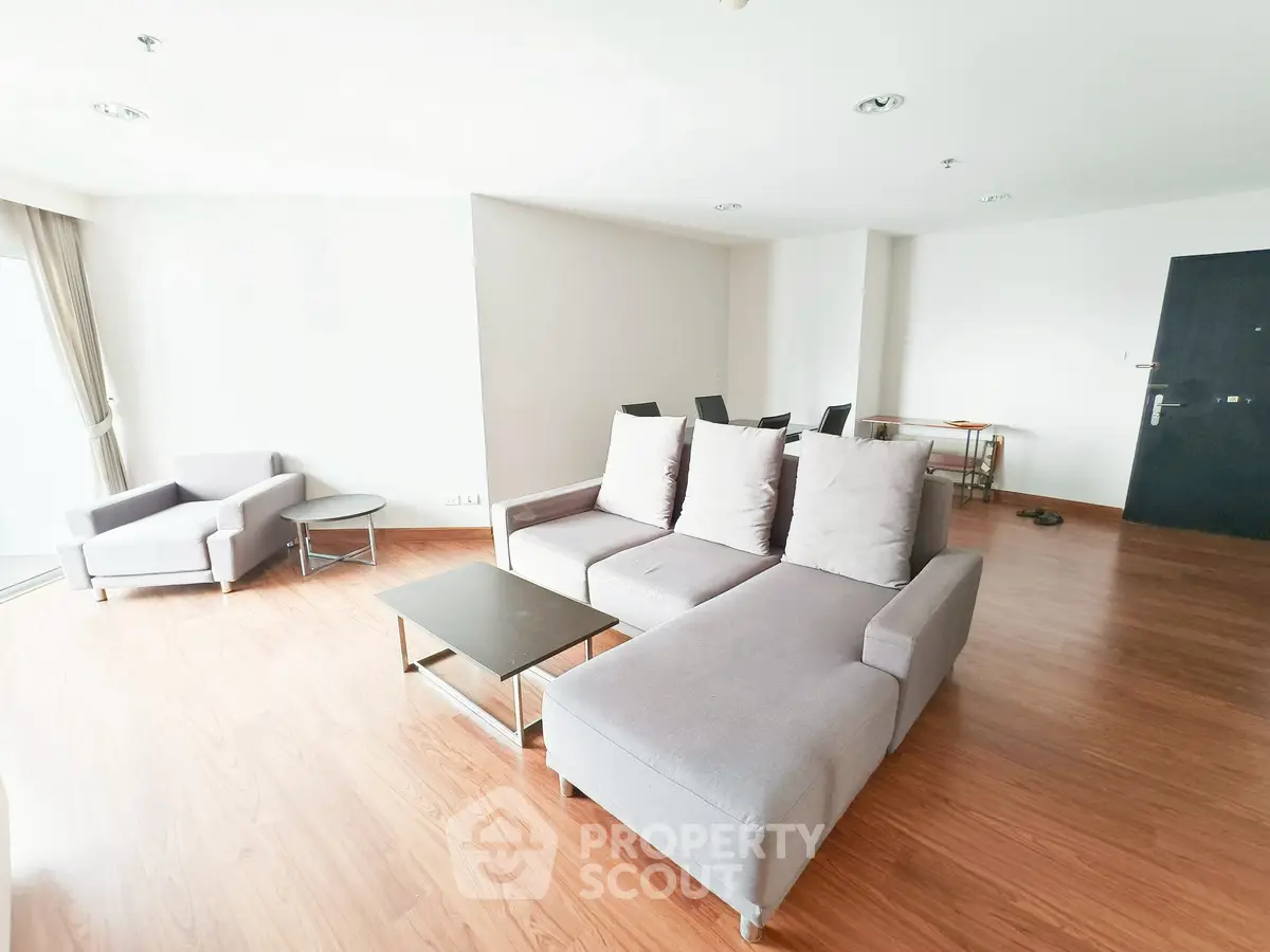 Spacious modern living room with sleek furniture and wooden flooring