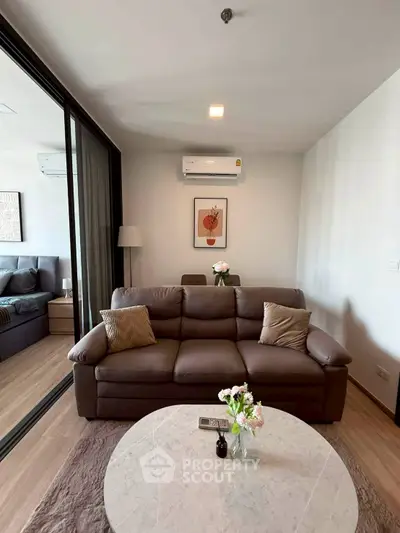 Modern living room with cozy sofa and stylish decor in a contemporary apartment.
