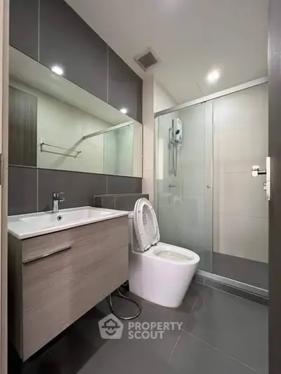 Modern bathroom with sleek fixtures and glass shower enclosure