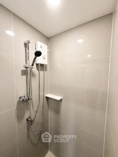 Modern bathroom shower with sleek tiles and water heater