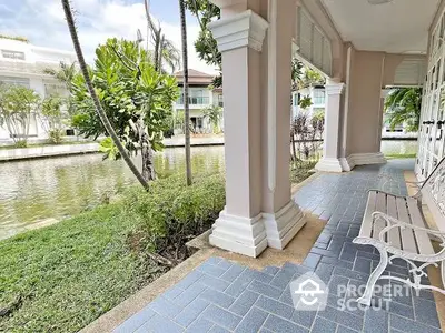 Charming waterfront property with spacious patio and lush greenery, perfect for relaxation and outdoor enjoyment.