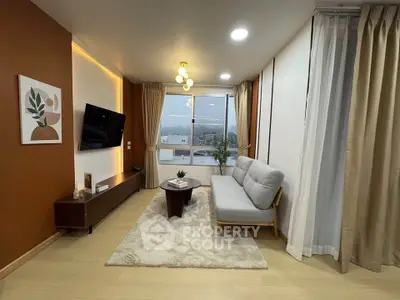 Modern living room with stylish decor and large window view