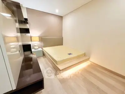 Modern minimalist bedroom with platform bed and sleek lighting