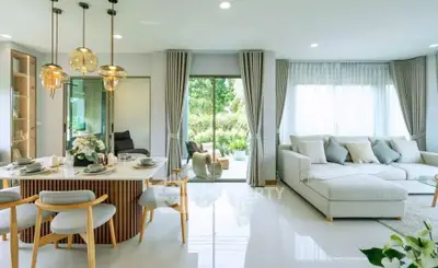 Spacious modern living room with elegant dining area and garden view.